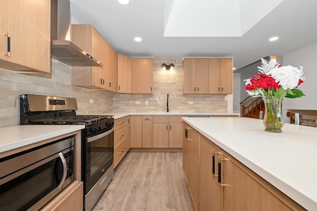 12123 S 72nd Ct, Palos Heights, IL 60463 - kitchen with wall chimney exhaust hood, stainless steel appliances, light brown cabinets, light countertops, and light wood finished floors