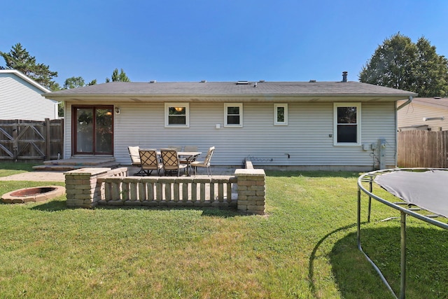 4113 Luckie Ct, Zion, IL 60099 - rear view of property with a trampoline, a patio area, and an outdoor fire pit