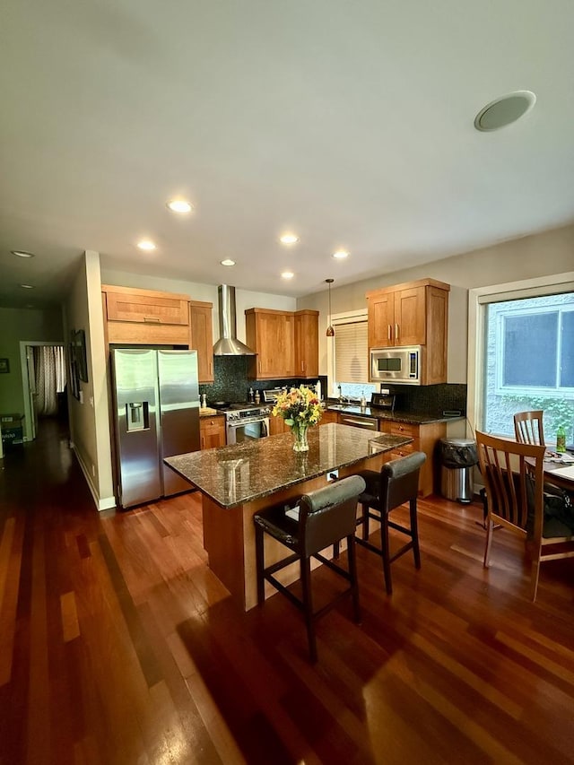 1621 W Le Moyne St Unit 1W, Chicago, IL 60622 - kitchen with appliances with stainless steel finishes, wall chimney exhaust hood, decorative backsplash, dark wood-style flooring, and recessed lighting