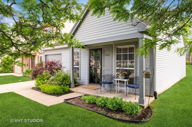 5145 Pembrook Ct, Gurnee, IL 60031 - view of front facade featuring a front yard, a porch, and an attached garage