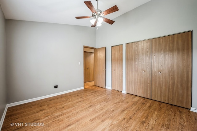5145 Pembrook Ct, Gurnee, IL 60031 - unfurnished bedroom with two closets, light wood-style flooring, high vaulted ceiling, and a ceiling fan