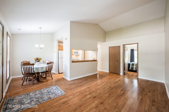 5145 Pembrook Ct, Gurnee, IL 60031 - dining area with a chandelier, wood finished floors, and high vaulted ceiling