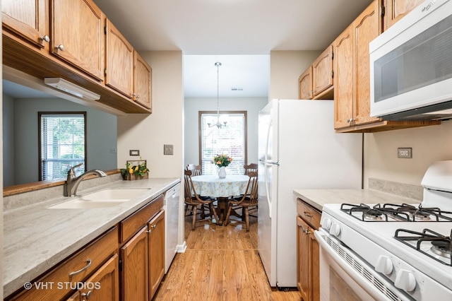 5145 Pembrook Ct, Gurnee, IL 60031 - kitchen with white appliances, light wood finished floors, pendant lighting, and a chandelier