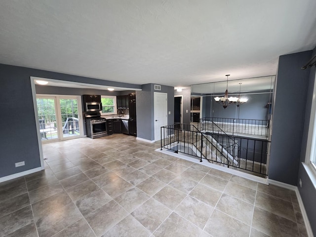 423 W Walnut Dr, Streamwood, IL 60107 - unfurnished living room featuring a chandelier and tile patterned floors