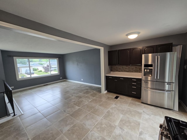 423 W Walnut Dr, Streamwood, IL 60107 - kitchen featuring appliances with stainless steel finishes, light countertops, decorative backsplash, and light tile patterned floors