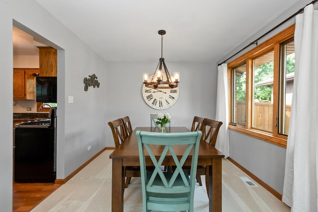 8648 Carriage Ln, Tinley Park, IL 60487 - dining room featuring a chandelier and baseboards