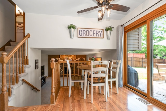 8648 Carriage Ln, Tinley Park, IL 60487 - dining space with wood finished floors, a ceiling fan, and stairs