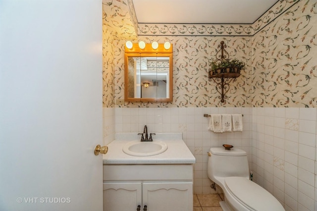 626 Barberry Rd, Highland Park, IL 60035 - half bath featuring wallpapered walls, vanity, tile walls, a wainscoted wall, and tile patterned floors