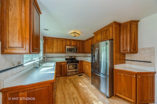 626 Barberry Rd, Highland Park, IL 60035 - kitchen with stainless steel appliances, brown cabinetry, and light countertops