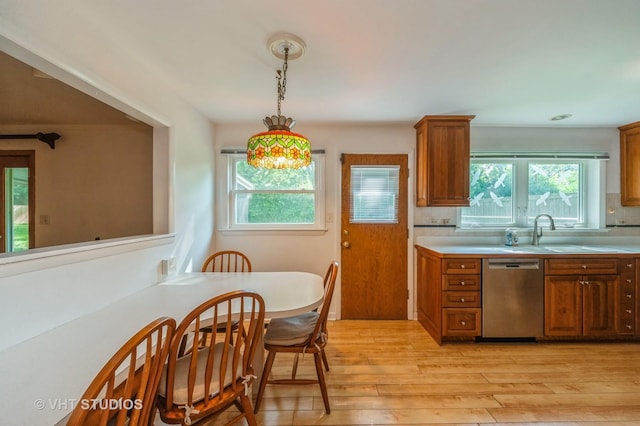 626 Barberry Rd, Highland Park, IL 60035 - kitchen featuring stainless steel dishwasher, light wood-type flooring, light countertops, and healthy amount of natural light