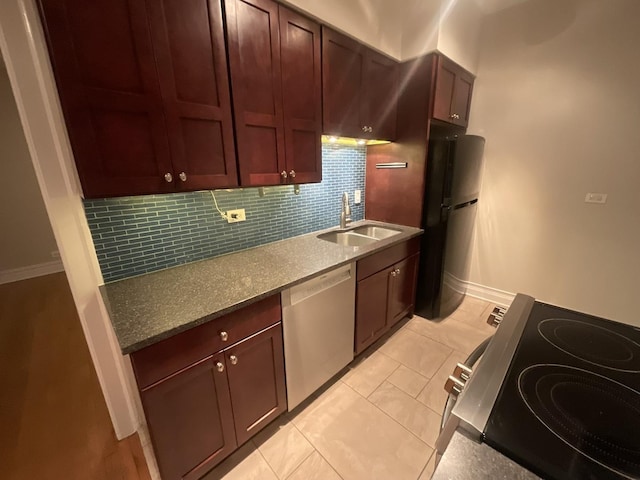 6257 N Sheridan Rd Unit 39, Chicago, IL 60660 - kitchen featuring stainless steel appliances, backsplash, dark stone counters, and light tile patterned floors