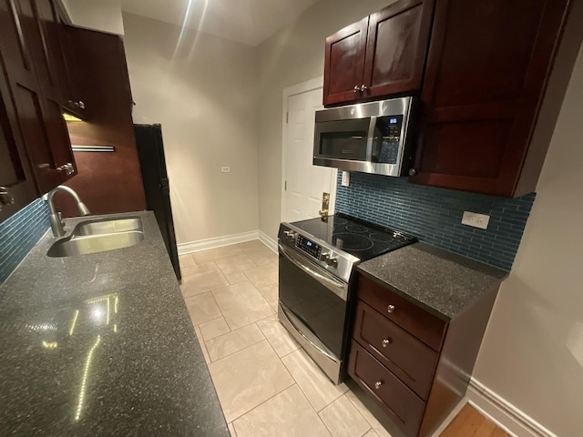 6257 N Sheridan Rd Unit 39, Chicago, IL 60660 - kitchen with appliances with stainless steel finishes, decorative backsplash, dark stone counters, and dark brown cabinets