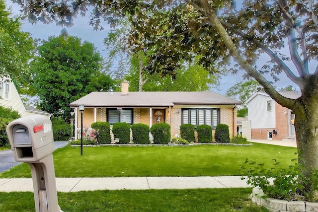 126 Oak Ave, Wood Dale, IL 60191 - view of front of home featuring brick siding, a front yard, and a chimney