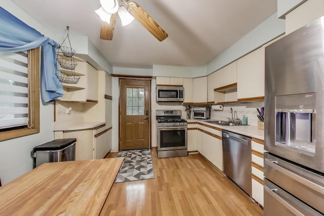 126 Oak Ave, Wood Dale, IL 60191 - kitchen featuring stainless steel appliances, open shelves, light countertops, a ceiling fan, and light wood-style floors