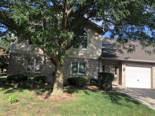 181 Saenz Ln Unit 181, Joliet, IL 60436 - view of front facade featuring brick siding, a garage, concrete driveway, and a front lawn