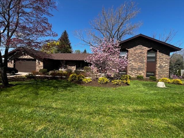 26587 N Cherrywood Ln, Wauconda, IL 60084 - view of front of home featuring a front lawn, an attached garage, and brick siding