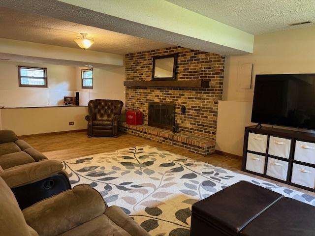 26587 N Cherrywood Ln, Wauconda, IL 60084 - living room with a textured ceiling, wood finished floors, and a fireplace