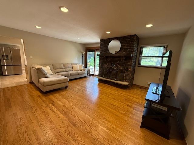 26587 N Cherrywood Ln, Wauconda, IL 60084 - living room with light wood-style flooring, recessed lighting, and a brick fireplace