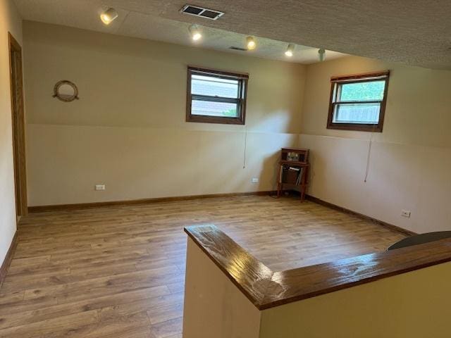 26587 N Cherrywood Ln, Wauconda, IL 60084 - empty room with healthy amount of natural light and wood finished floors
