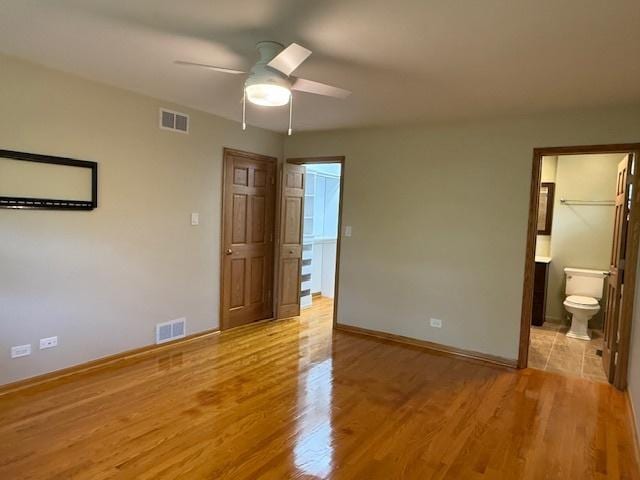 26587 N Cherrywood Ln, Wauconda, IL 60084 - unfurnished bedroom with light wood-type flooring, a ceiling fan, and ensuite bath