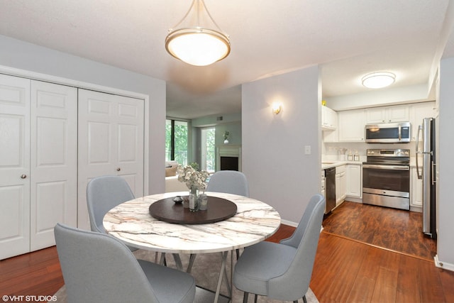 509 Aurora Ave Unit 305, Naperville, IL 60540 - dining space with dark wood finished floors and baseboards