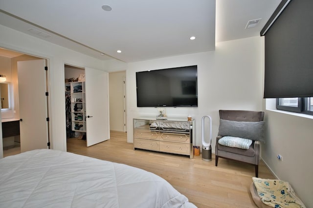 522 N Western Ave Unit 201, Chicago, IL 60612 - bedroom featuring wood finished floors, ensuite bathroom, a spacious closet, and recessed lighting