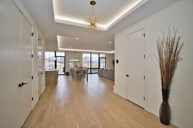 522 N Western Ave Unit 201, Chicago, IL 60612 - foyer featuring a tray ceiling, light wood finished floors, recessed lighting, and a chandelier