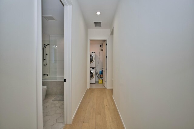 522 N Western Ave Unit 201, Chicago, IL 60612 - corridor featuring estacked washer and dryer, light wood-type flooring, and recessed lighting