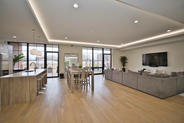 522 N Western Ave Unit 201, Chicago, IL 60612 - dining space featuring a raised ceiling, expansive windows, plenty of natural light, light wood-style flooring, and recessed lighting