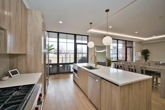 522 N Western Ave Unit 201, Chicago, IL 60612 - kitchen featuring modern cabinets, stainless steel appliances, light brown cabinetry, floor to ceiling windows, and recessed lighting