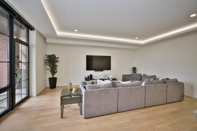 522 N Western Ave Unit 201, Chicago, IL 60612 - living area with healthy amount of natural light, a raised ceiling, light wood finished floors, and recessed lighting