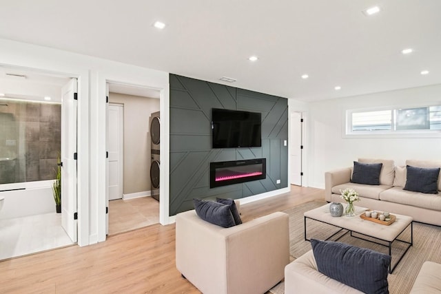 8127 Gross Point Rd, Morton Grove, IL 60053 - living area with stacked washer / drying machine, a fireplace, recessed lighting, and light wood-type flooring