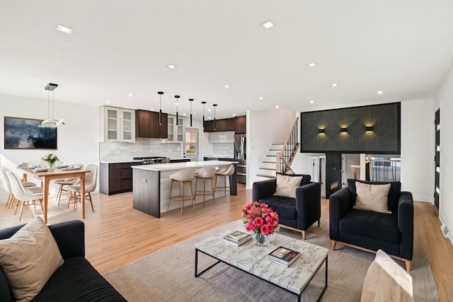 8127 Gross Point Rd, Morton Grove, IL 60053 - living room with light wood-style flooring, recessed lighting, and stairway