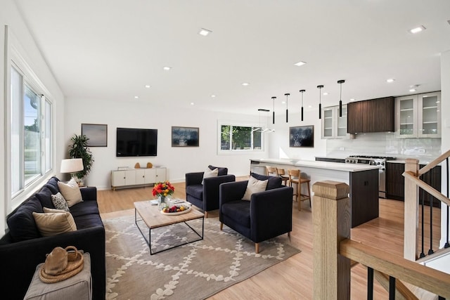 8127 Gross Point Rd, Morton Grove, IL 60053 - living area featuring light wood finished floors and recessed lighting