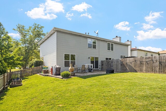 504 N Reef Rd, Lockport, IL 60441 - back of house featuring a patio, a fenced backyard, and a chimney