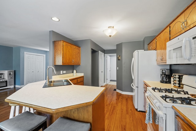 504 N Reef Rd, Lockport, IL 60441 - kitchen with white appliances, a peninsula, light countertops, brown cabinets, and recessed lighting