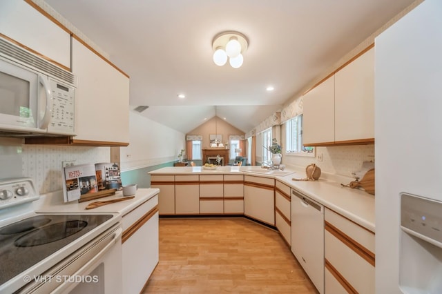 1808 N Normandy Ct, Arlington Heights, IL 60004 - kitchen featuring white appliances, light countertops, light wood-style floors, vaulted ceiling, and a peninsula