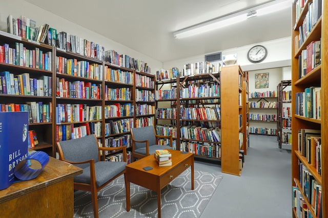 3150 N Lake Shore Dr Unit 8E, Chicago, IL 60657 - sitting room featuring wall of books and finished concrete floors