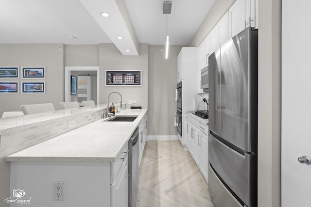 233 E 13th St Unit 2402, Chicago, IL 60605 - kitchen with appliances with stainless steel finishes, recessed lighting, white cabinetry, a peninsula, and hanging light fixtures