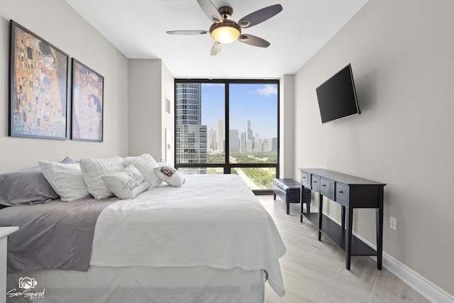 233 E 13th St Unit 2402, Chicago, IL 60605 - bedroom with a wall of windows, light wood-type flooring, and ceiling fan