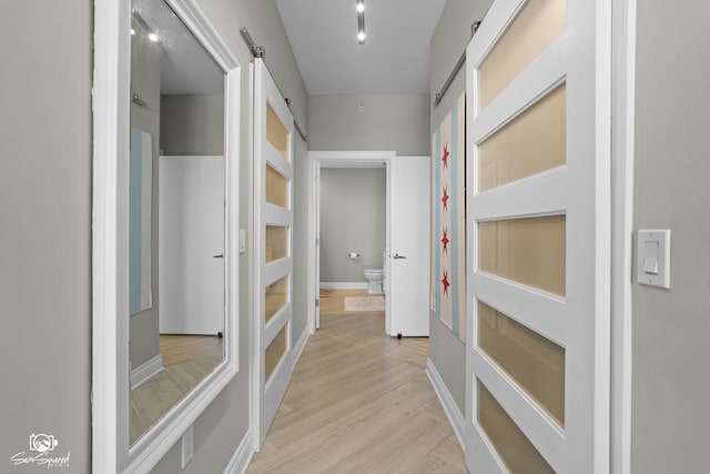 233 E 13th St Unit 2402, Chicago, IL 60605 - corridor with a barn door and light wood-style floors