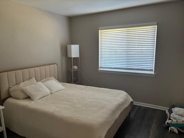9388 Bay Colony Dr Unit 1S, Des Plaines, IL 60016 - bedroom featuring dark wood finished floors and baseboards