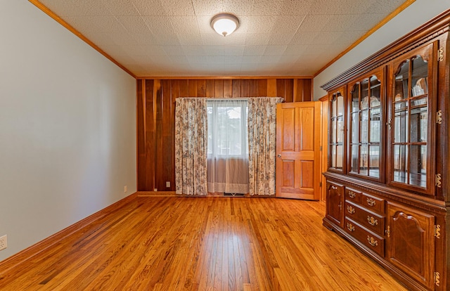 102 S Oak St, Arrowsmith, IL 61722 - unfurnished room with crown molding, wooden walls, and light wood finished floors