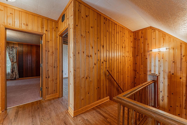 102 S Oak St, Arrowsmith, IL 61722 - corridor with an upstairs landing, vaulted ceiling, wooden walls, and wood finished floors