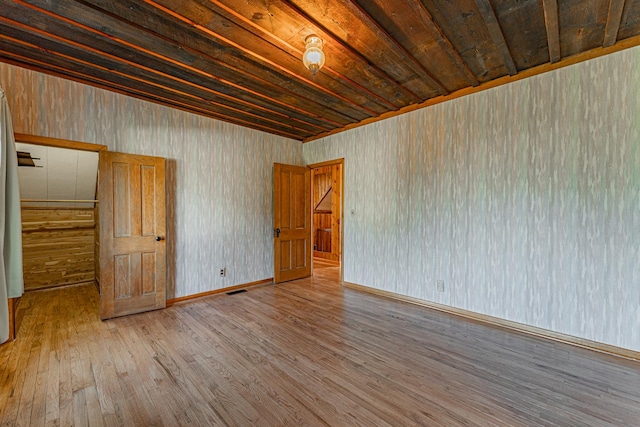 102 S Oak St, Arrowsmith, IL 61722 - empty room with wood-type flooring and wooden ceiling
