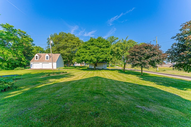 102 S Oak St, Arrowsmith, IL 61722 - view of grassy yard featuring an outdoor structure and an attached garage