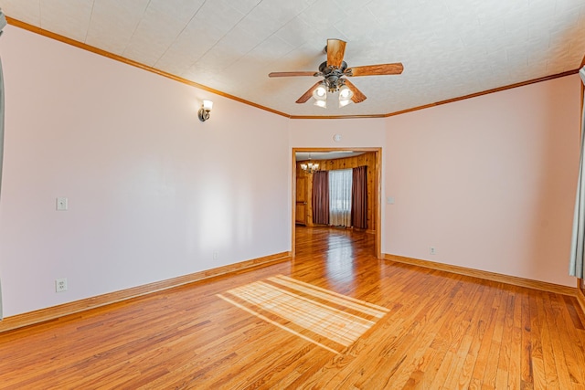 102 S Oak St, Arrowsmith, IL 61722 - empty room with hardwood / wood-style floors, a chandelier, a ceiling fan, and crown molding