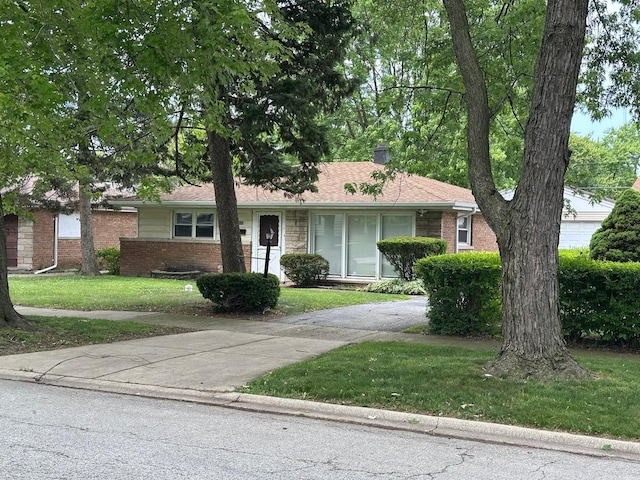 17332 Roy St, Lansing, IL 60438 - ranch-style house featuring a front yard, brick siding, and driveway