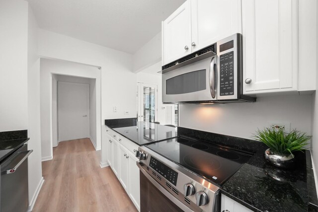 400 N Lasalle Dr Unit 2007, Chicago, IL 60654 - kitchen with stainless steel appliances, light wood-type flooring, white cabinetry, and dark stone countertops