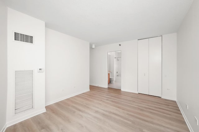 400 N Lasalle Dr Unit 2007, Chicago, IL 60654 - unfurnished bedroom with light wood-type flooring, ensuite bath, and a closet